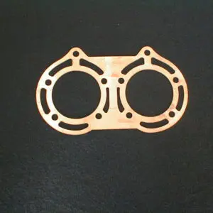 A Copper Cylinder Head Spacer .080" on a black surface, suitable for Yamaha Banshee.