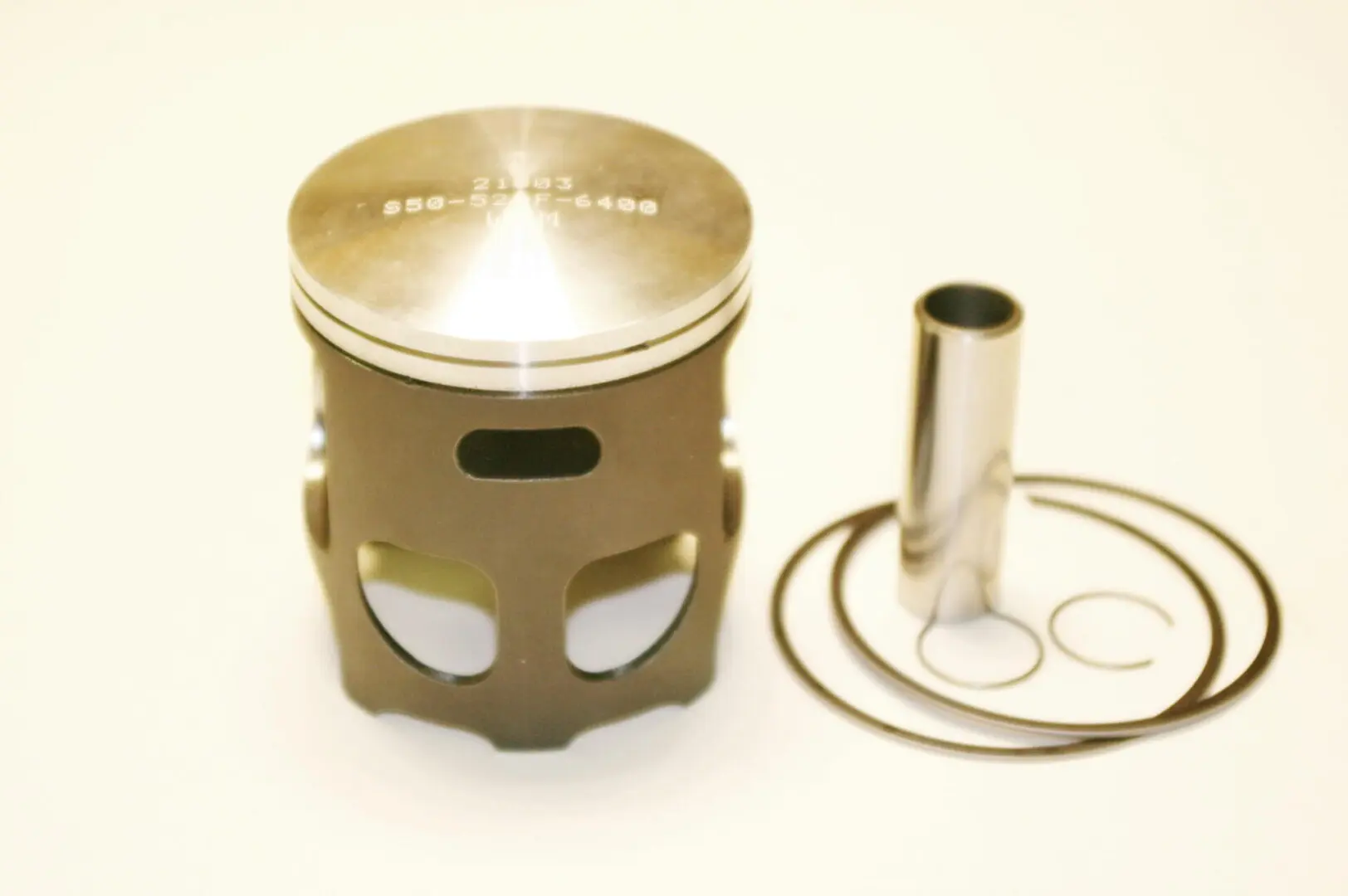 A piston with a WSM Part# 50-520-5, TDR, Forged Lightweight Long Rod Piston kit and a piston ring.