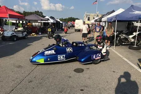 A blue race car is parked in a parking lot.