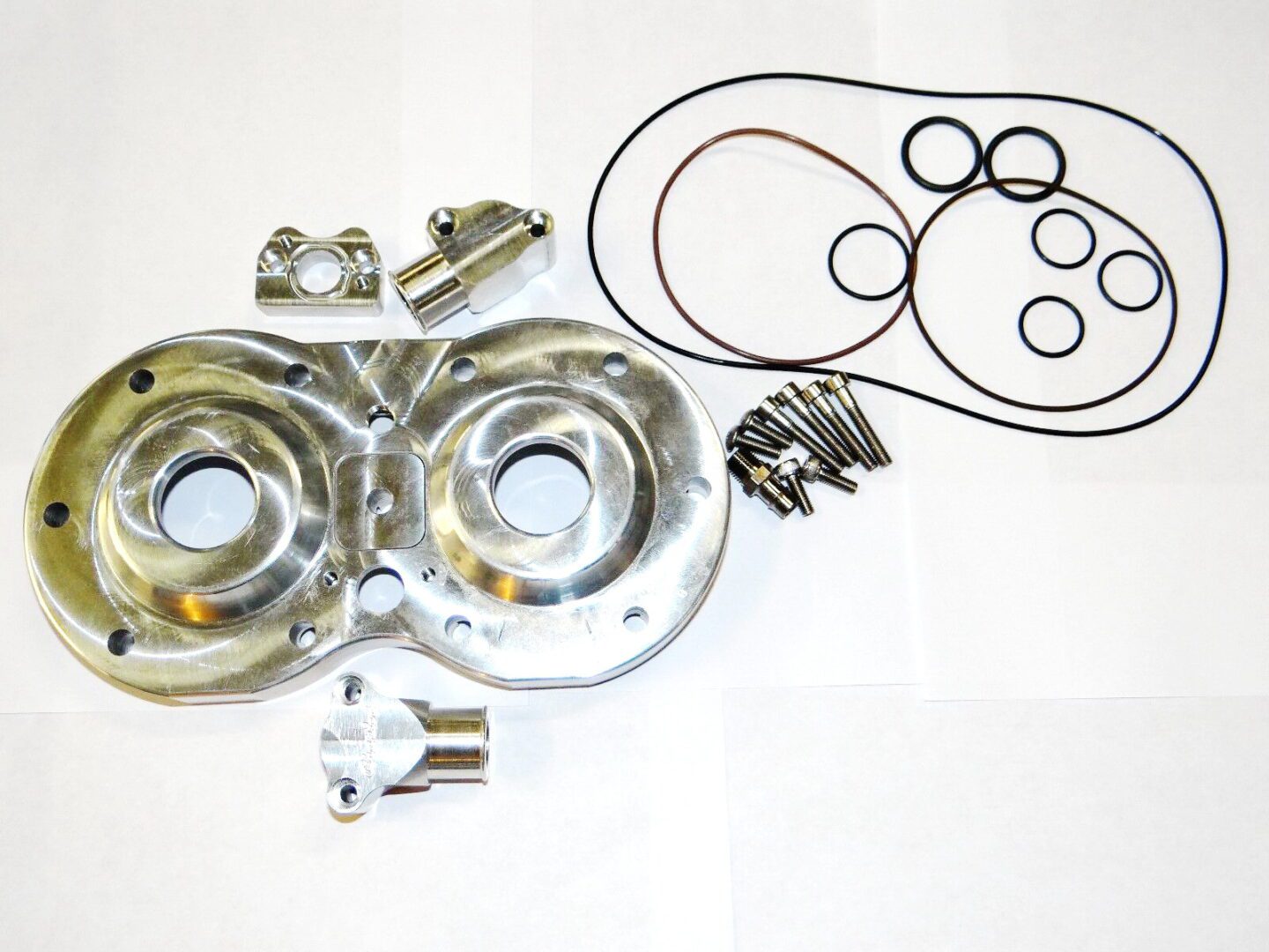 A set of gaskets and seals on a white surface, featuring the DM/Cheetah billet head Chariot, Part# 21-5832.