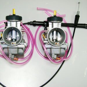 Two 38mm Keihin "PWK" Air Striker Carburetor Kits, Part 22-5767, with pink hoses attached to them.