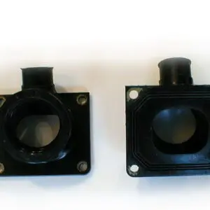 Two black plastic pipe fittings on a white surface beside a WSM Intake Manifold for stock 28mm carburetor, Part# 22-5824.