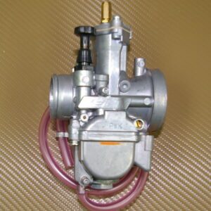 An image of a 28mm PWK Keihin Carburetor Kit, Part 22-5841 with a pink hose.