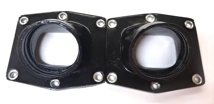 A pair of black plastic flanges on a white surface, suitable for use with the BIG 50mm UPP INTAKE MANIFOLD, Part# 22-5881.