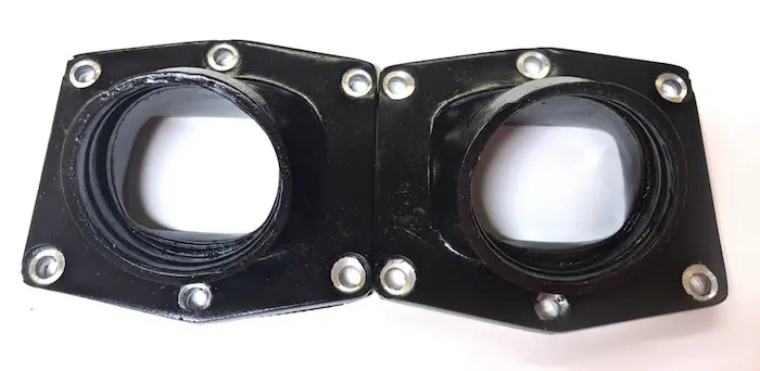 A pair of plastic flanges for UPP Intake Manifold for Cheetah Cylinders 38-41mm carbs, Part# 22-5981 on a white surface.