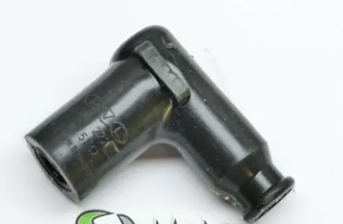 A black plastic PVL resistor spark plug cap with a green logo and Part# 23-5823.