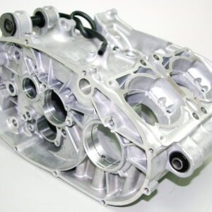 This silver OEM Yamaha Crankcase RZ 350 Banshee engine block is sitting on a white surface.