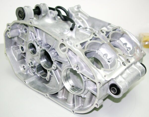 This silver OEM Yamaha Crankcase RZ 350 Banshee engine block is sitting on a white surface.