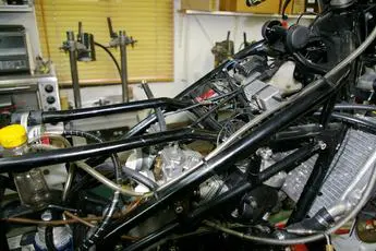 A motorcycle is being worked on in a garage.