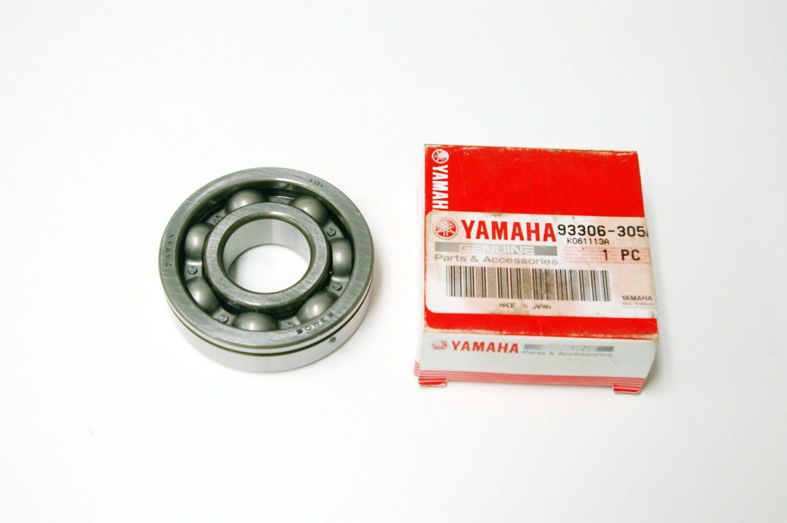A OEM Yamaha Crankshaft Bearing clutch side and bearing box on a white background.