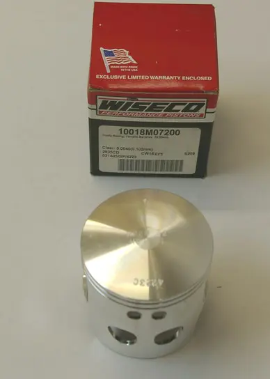 A Wiseco # 10018, Cheetah Super Cub Forged Piston Kit with a box in front of it, part# 10018.