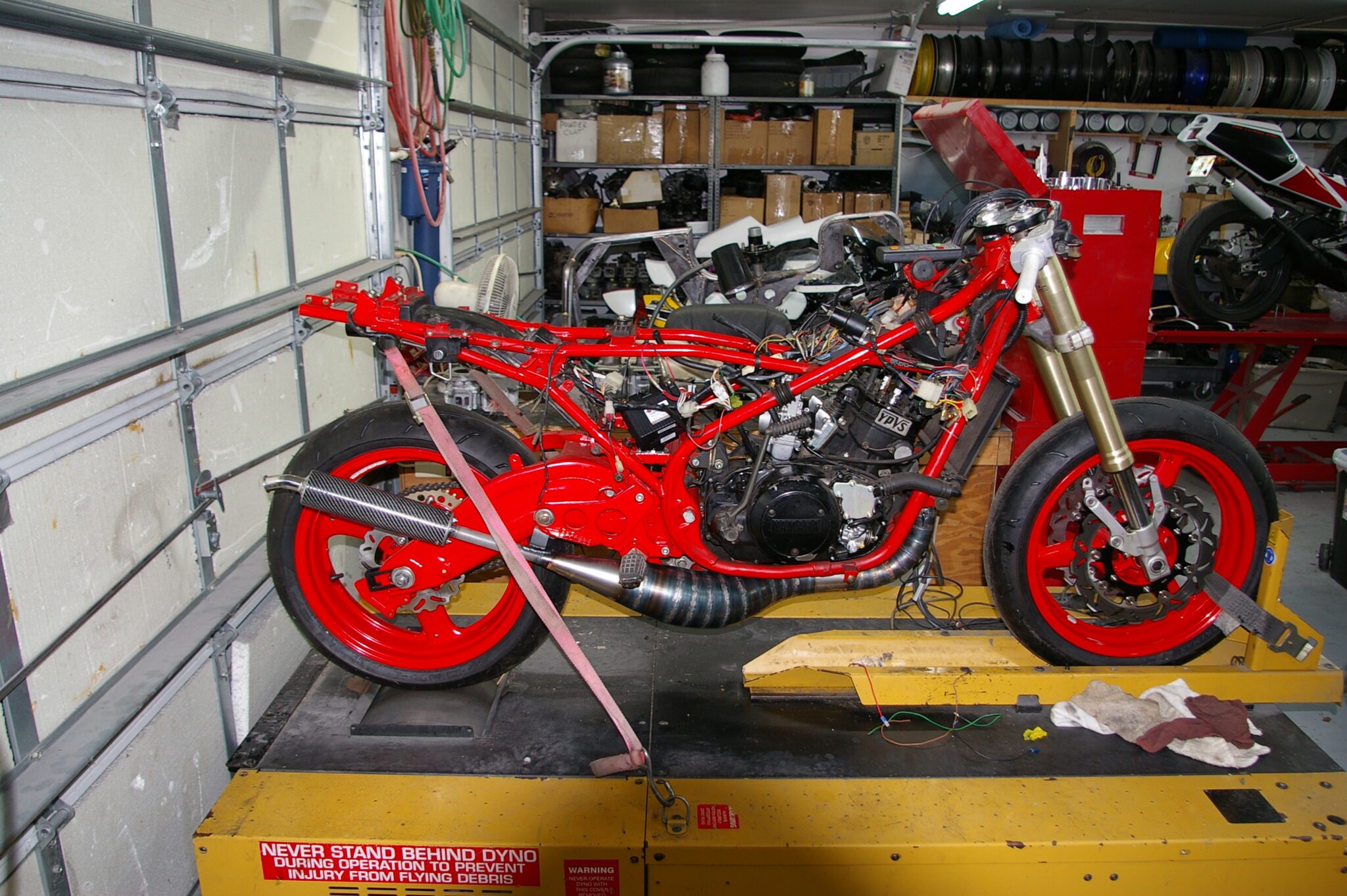 A red motorcycle in a garage.