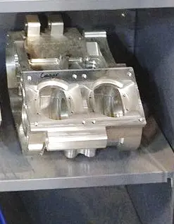 A set of Mattoon Machine Billet Crankcase, Yamaha Banshee, RZ 350, Part 91-5735 metal parts on a shelf.