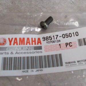 A silver screw with a black washer on a Yamaha parts bag.
