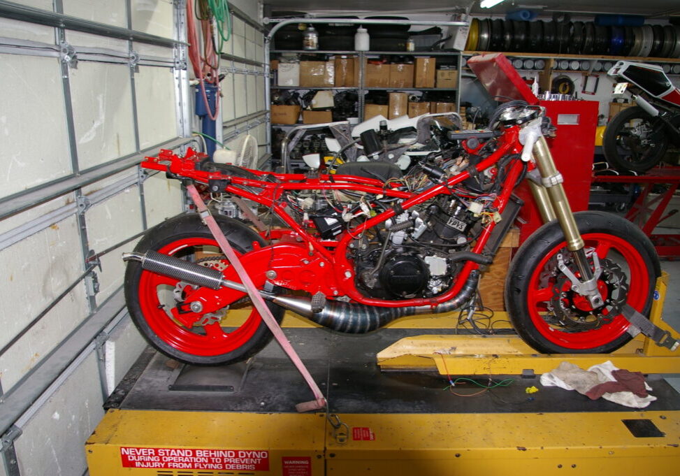 A red motorcycle in a garage.